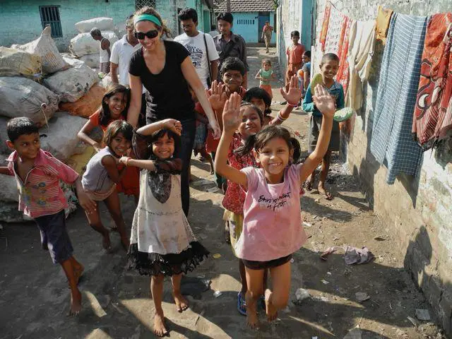 A group of children and adults in the street.